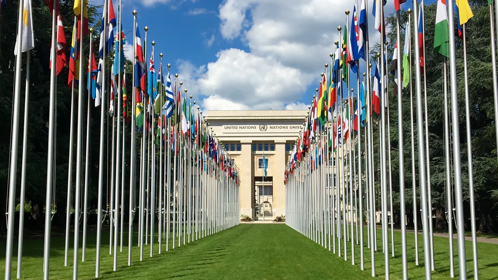 Rows of national flags leading to the Palais des Nations, the UN office in Geneva