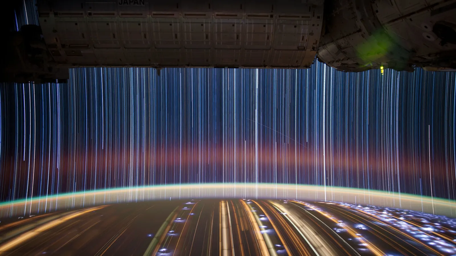 Star trails and city lights over the Earth, photographed from the International Space Station