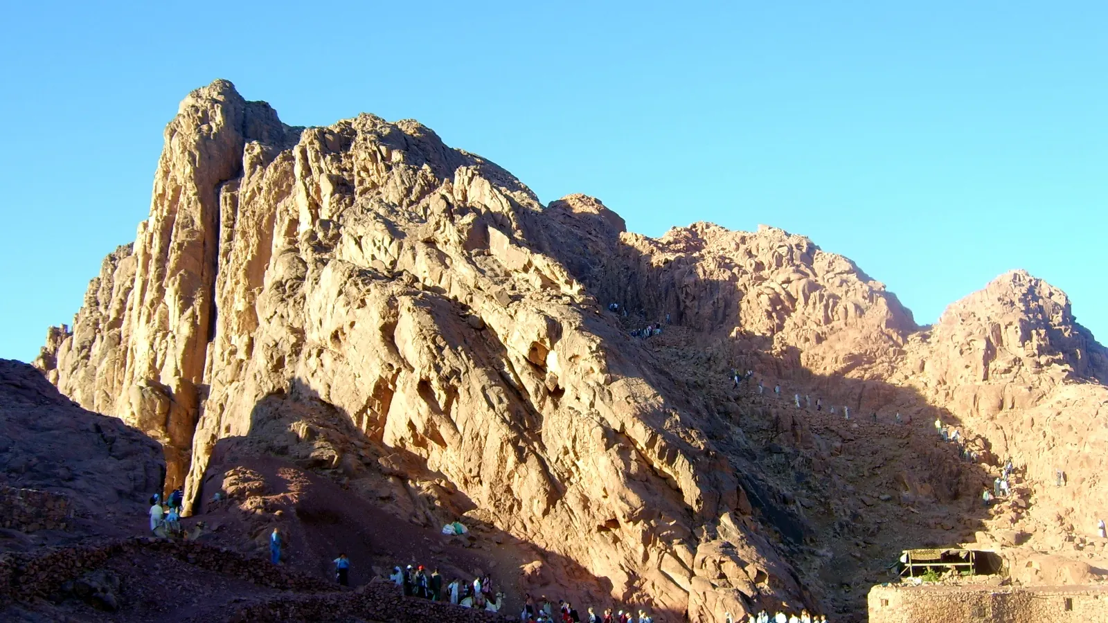 The rugged granite peaks of Mount Sinai under a blue sky