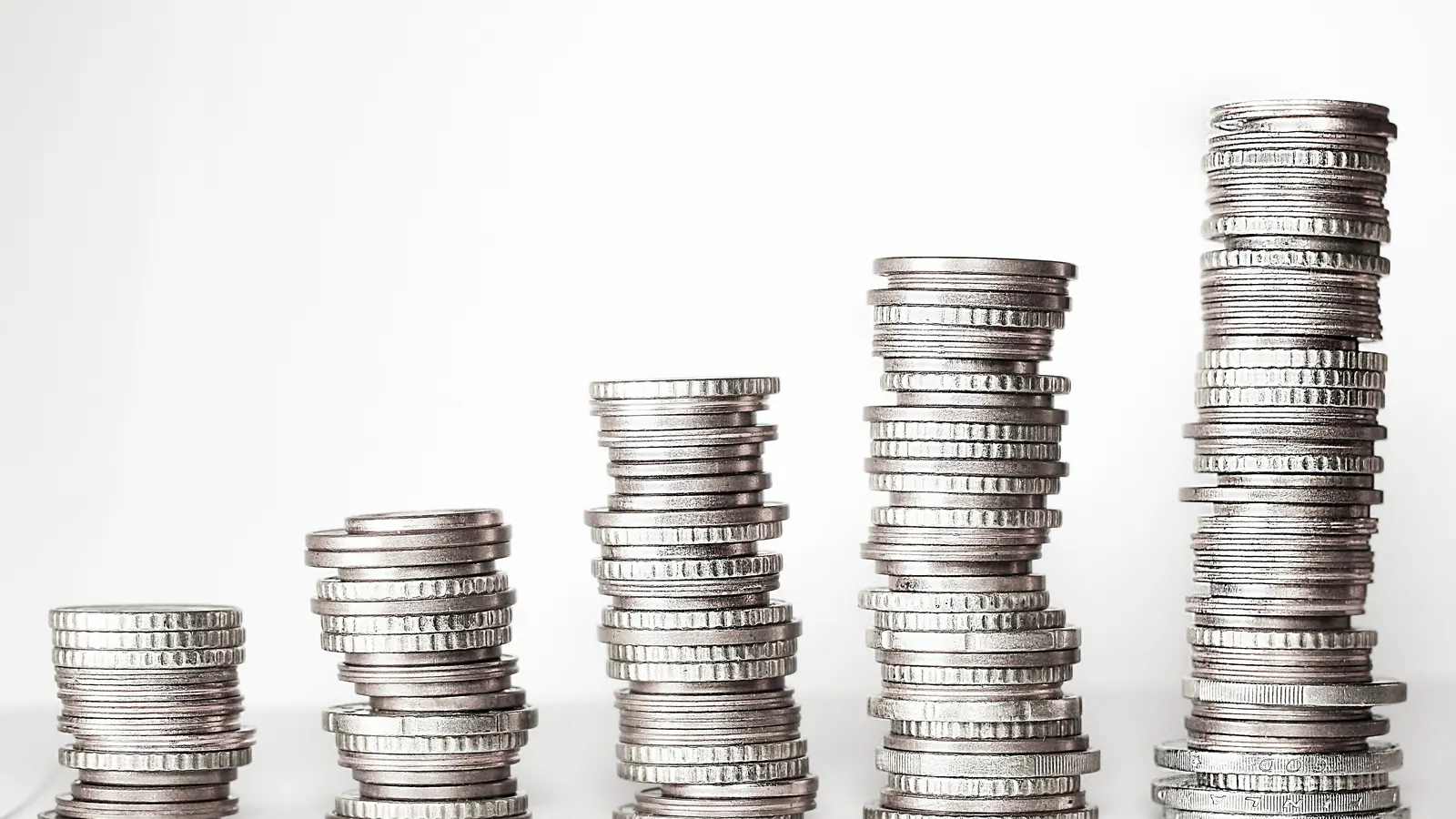 Stacks of coins rising in height from left to right